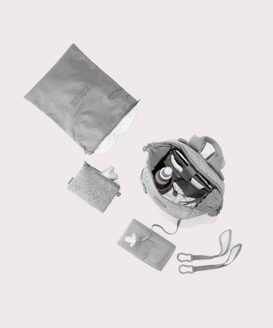 Dagne Dover small Indi Diaper Backpack in grey showing it's water resistant bag, interior pockets, and changing mat.