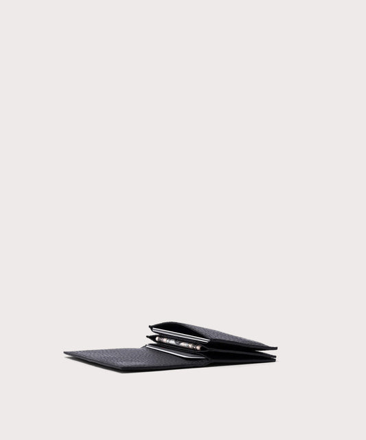 hover - Dagne Dover Accordion Card Case in black opened, revealing the three internal gusseted card slots.