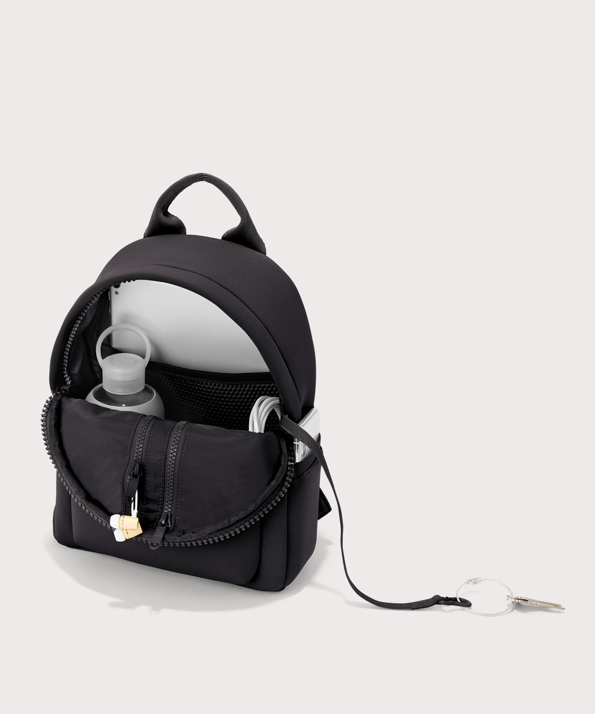 Dagne Dover Dakota Small Neoprene Backpack in black unzipped, revealing the interior air mesh pockets.
