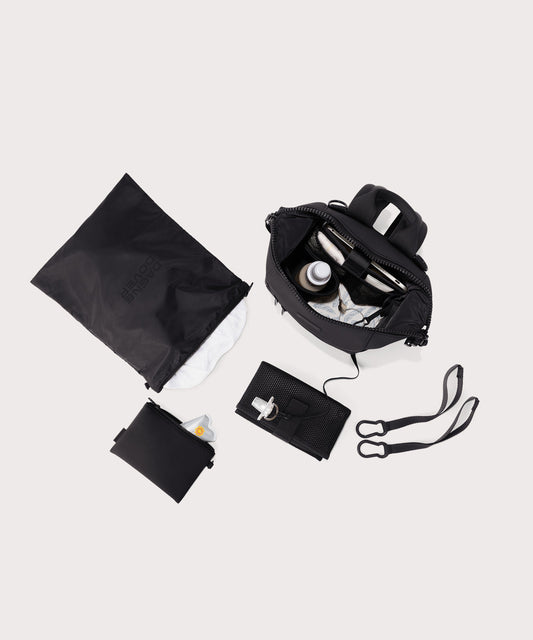 Dagne Dover small Indi Diaper Backpack in black showing it's water resistant bag, interior pockets, and changing mat.