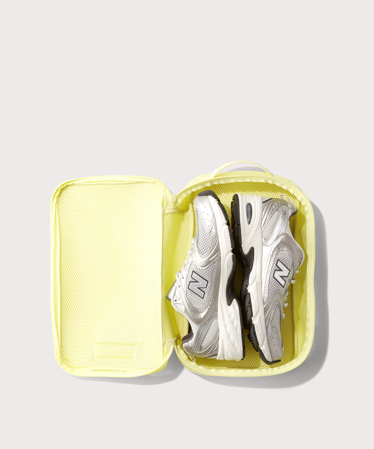 medium Roma packing cube in citrine open with jeans inside